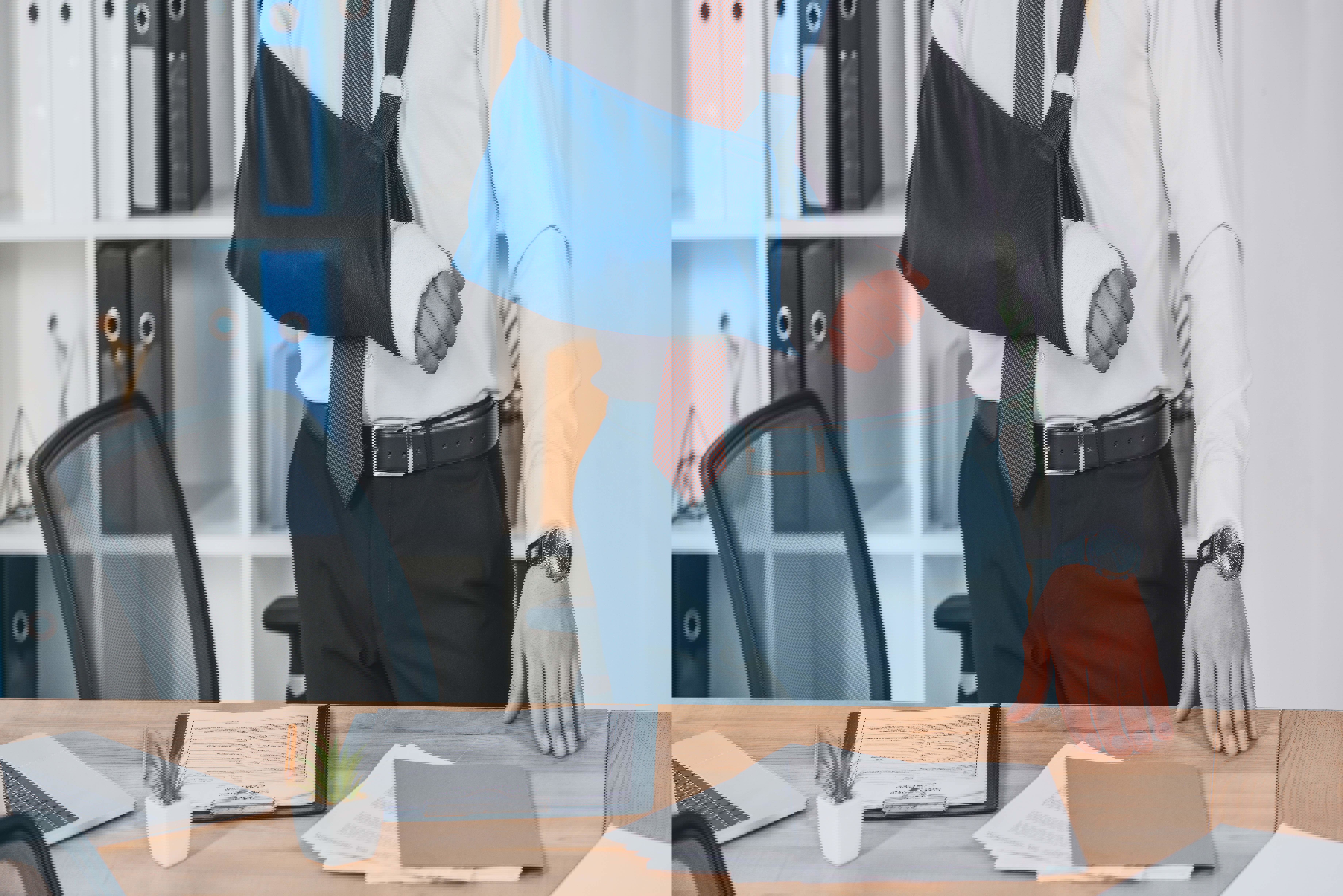 An office worker wearing a sling on his right arm